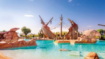 Top Piscines à Marrakech Personnes se détendant autour d’une piscine avec parasols dans le désert d’Agafay près de Marrakech